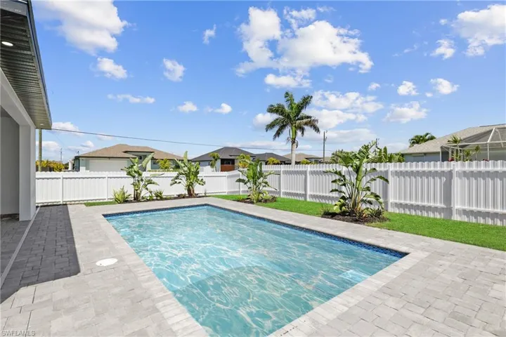 View of swimming pool with a fenced backyard and a patio area