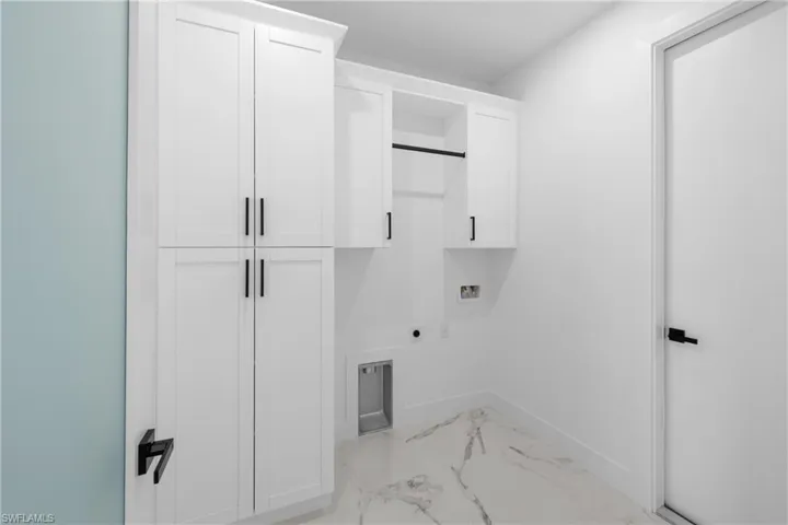 Laundry area with washer hookup, marble finish floor, baseboards, hookup for an electric dryer, and cabinet space