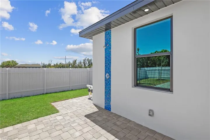 View of patio featuring fence