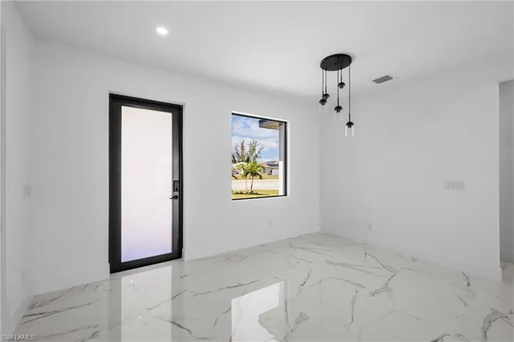 Spare room featuring marble finish floor, recessed lighting, baseboards, and visible vents