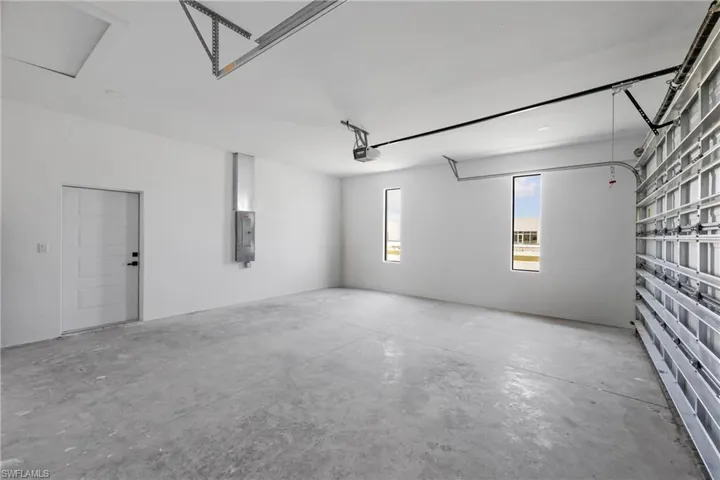 Garage with a garage door opener and electric panel