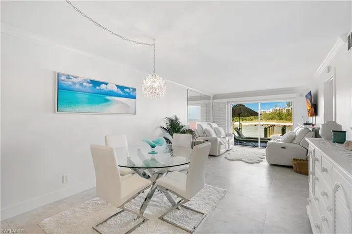 Dining room featuring crown molding and suspended lighting
