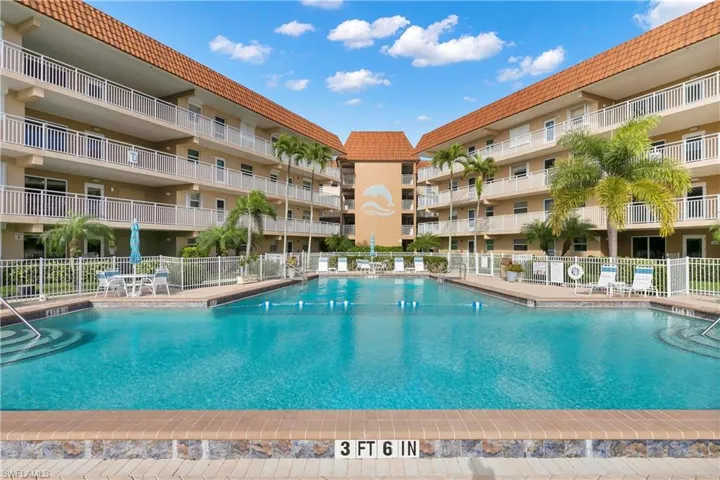 Community pool with a patio