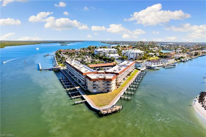 View of urban area with a nearby body of water and apartment complex / building