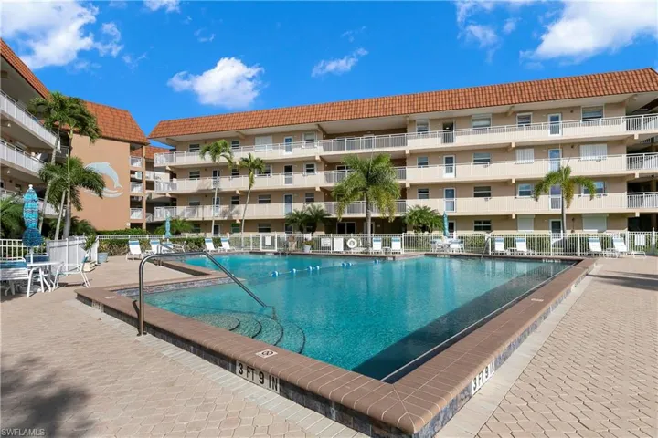 Community pool with a patio