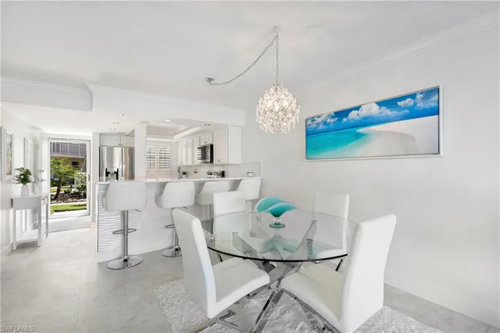 Dining space featuring crown molding and hanging lights