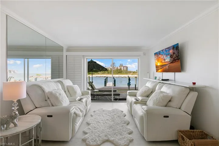 Living room with healthy amount of natural light and ornamental molding