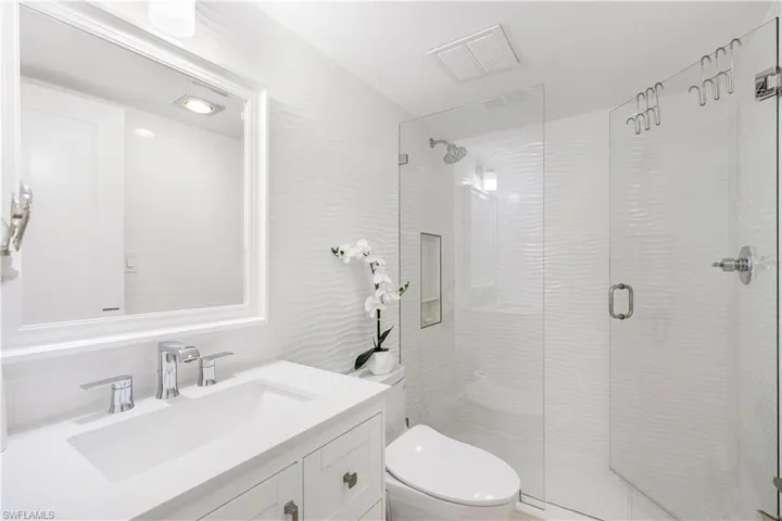 Bathroom with vanity and a shower stall