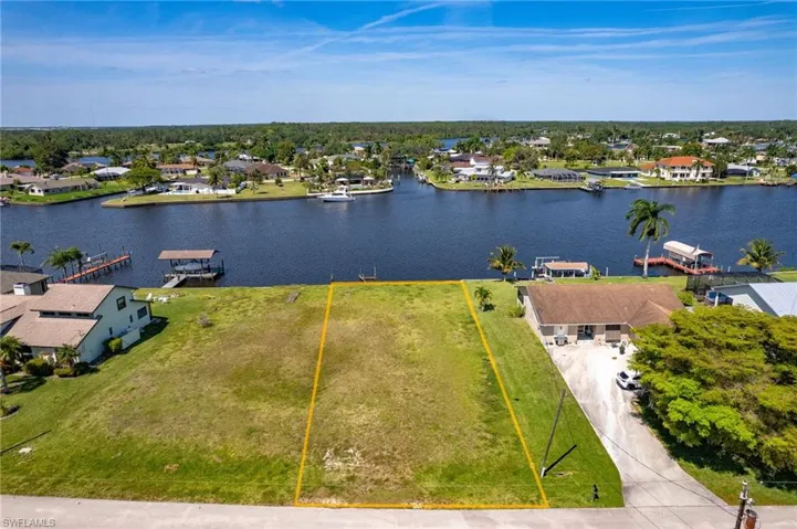 Birds eye view of property with a water view