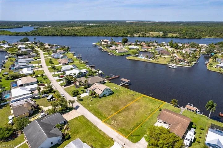 Birds eye view of property with a water view