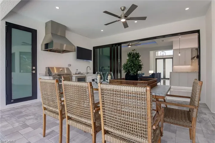 Dining space featuring french doors, ceiling fan, and sink