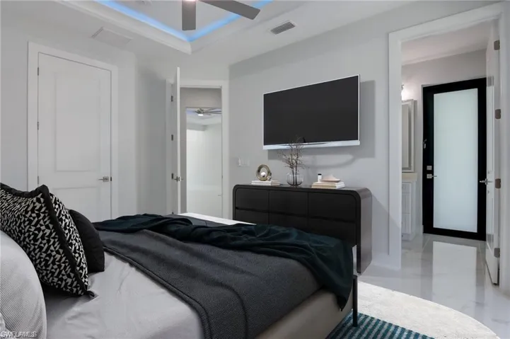 Bedroom with ceiling fan and ensuite bathroom
