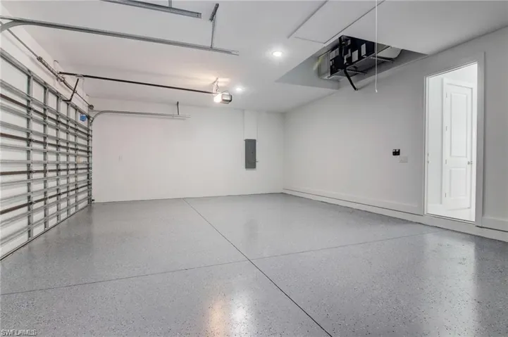 Garage with electric panel and a garage door opener