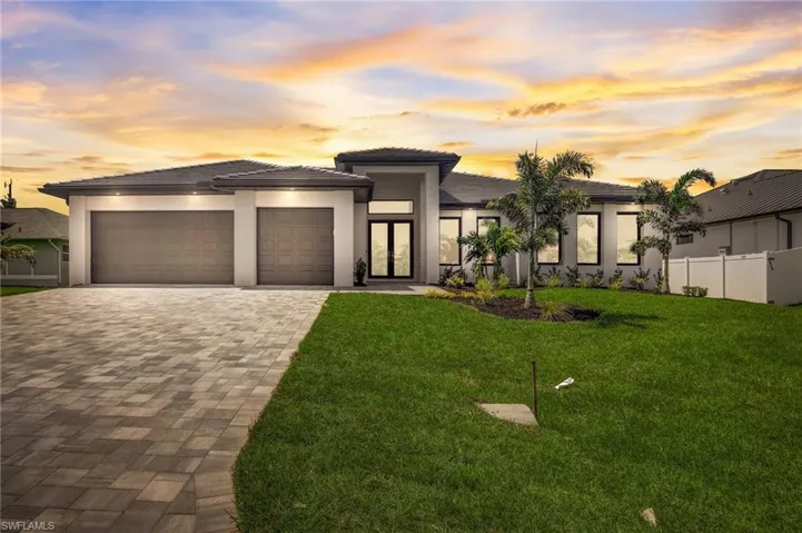 Prairie-style house with a lawn, french doors, and a garage