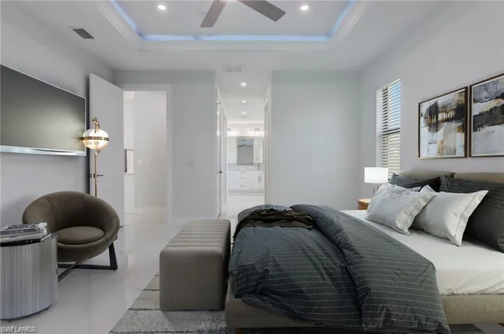Bedroom with a tray ceiling and ceiling fan
