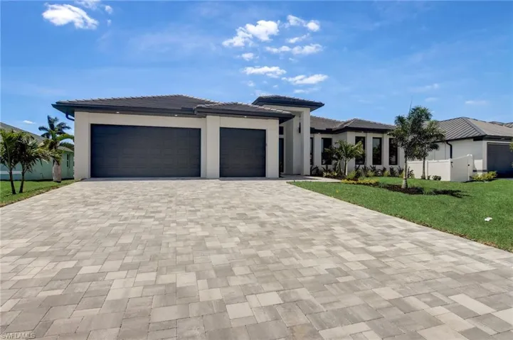Prairie-style house featuring a front lawn and a garage
