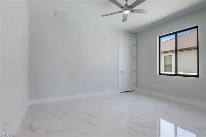Unfurnished room featuring ceiling fan