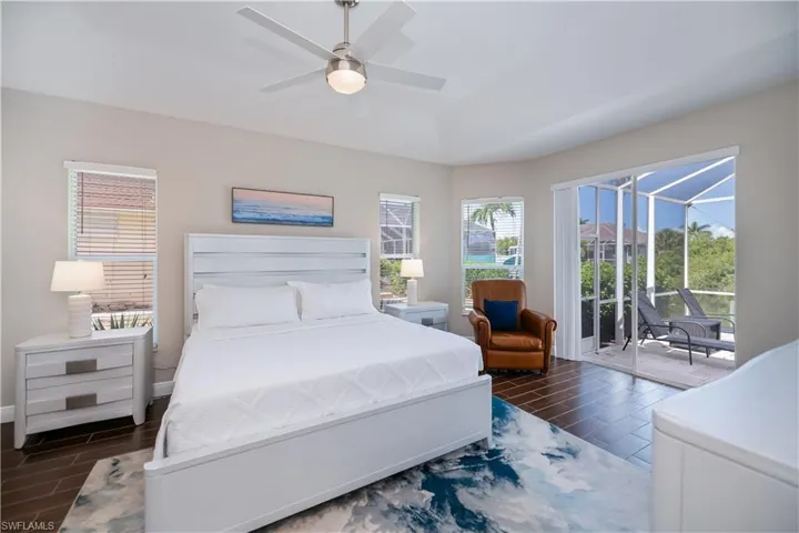 Large, bright master bedroom with sliders to the pool area