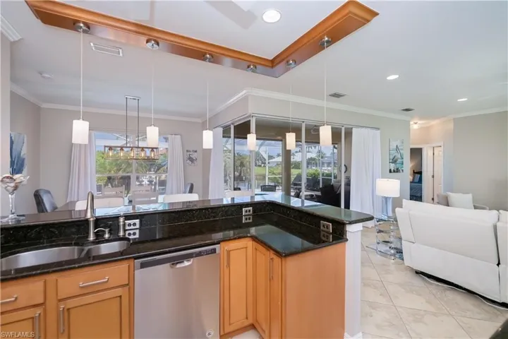 Open kitchen with wood cabinets and granite countertops