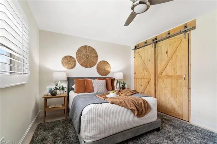 Real wood barn doors mask the closet.