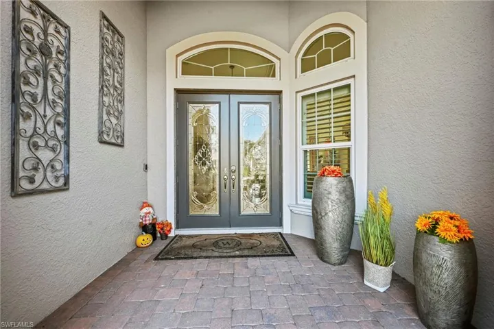 Property entrance featuring french doors and stucco siding
