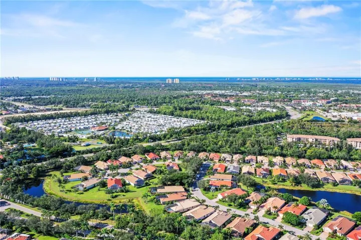 View of property location featuring a large body of water and nearby suburban area