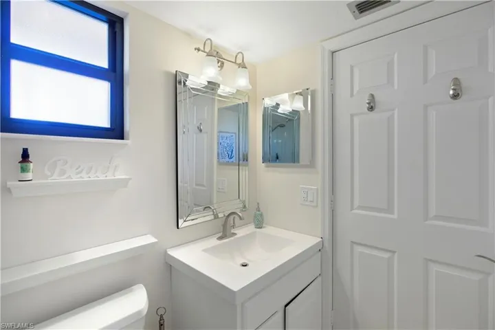 Half bathroom with vanity and toilet