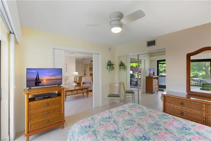 Bedroom featuring light tile patterned floors, a closet, and ceiling fan