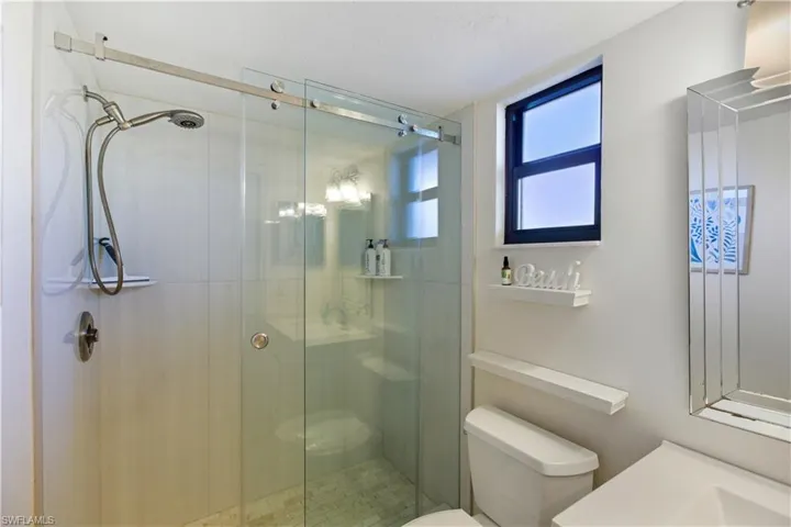 Bathroom with vanity and a shower stall