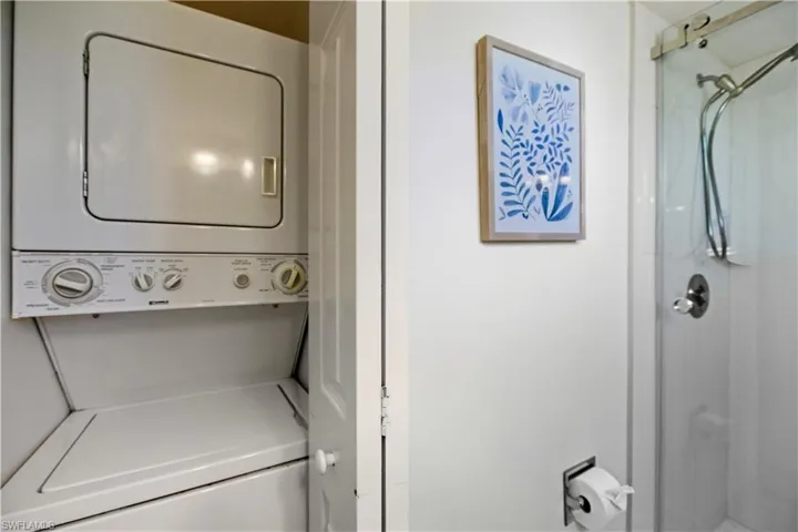 Laundry room featuring stacked washer and clothes dryer