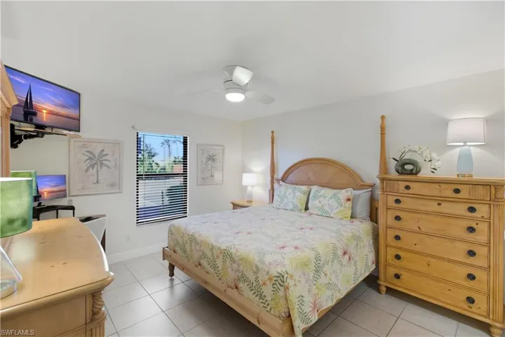 Bedroom featuring light tile patterned floors and ceiling fan