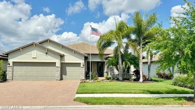 View of front of house featuring a garage and a front lawn