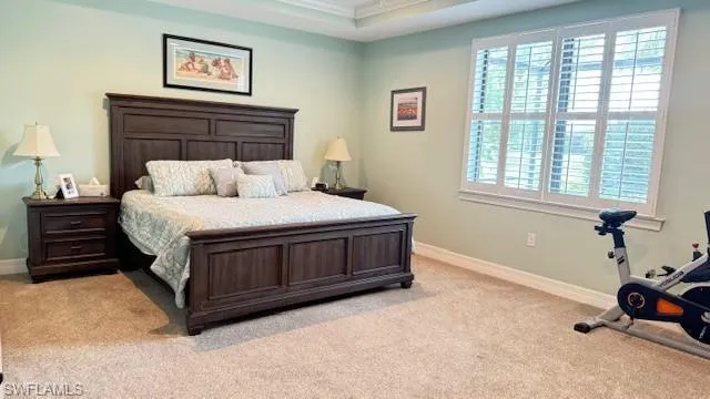 Bedroom featuring light carpet and crown molding