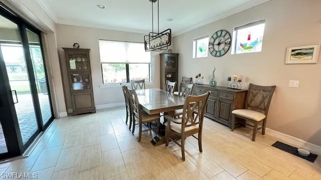 Dining space featuring crown molding and light wood-type flooring