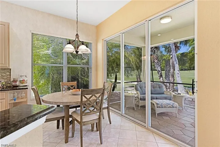 Dining area with light tile patterned floors