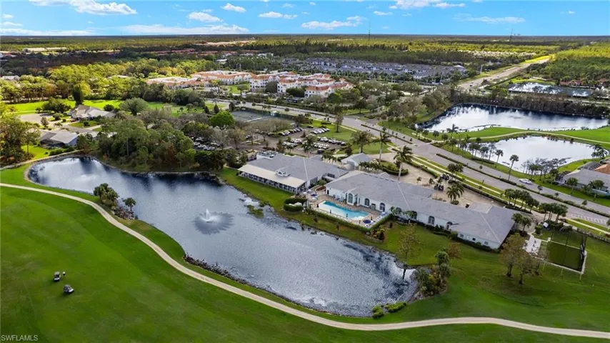Aerial view of residential area featuring a large body of water and a golf club
