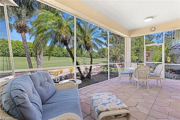 Sunroom / solarium featuring outdoor dining area and view of golf course