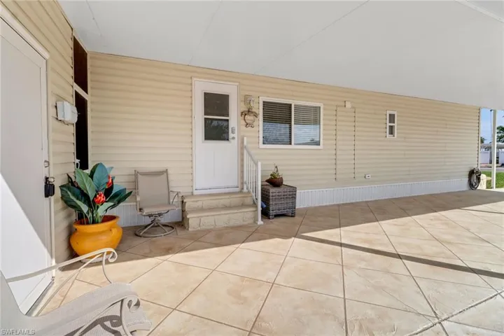 View of exterior entry with a patio