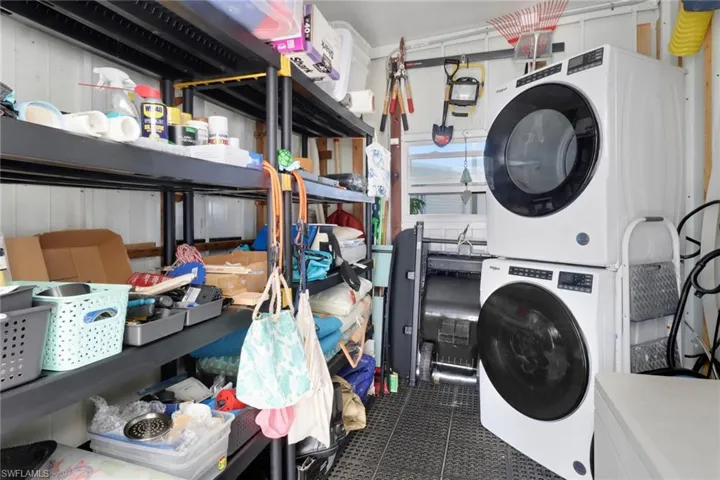 Laundry area with stacked washing maching and dryer