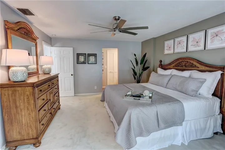 Bedroom with light colored carpet and ceiling fan