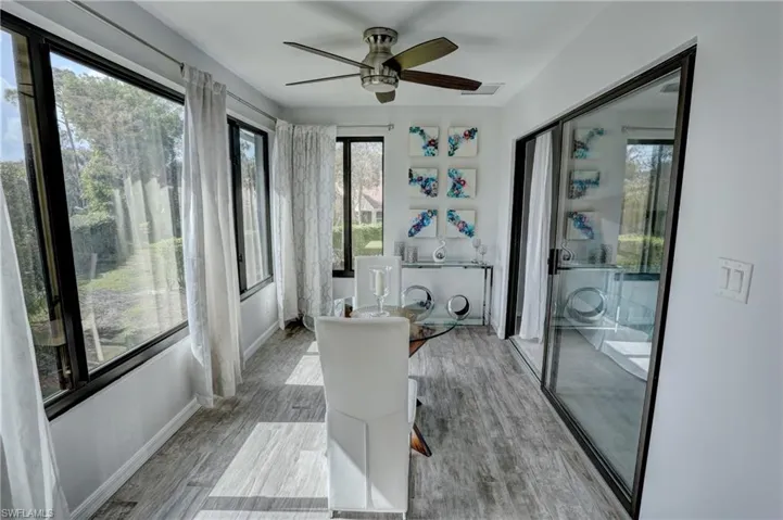 Sunroom / solarium featuring ceiling fan