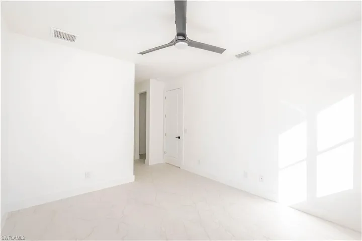 Spare room with baseboards and a ceiling fan