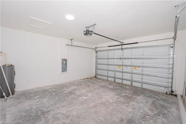 Garage with water heater and a garage door opener