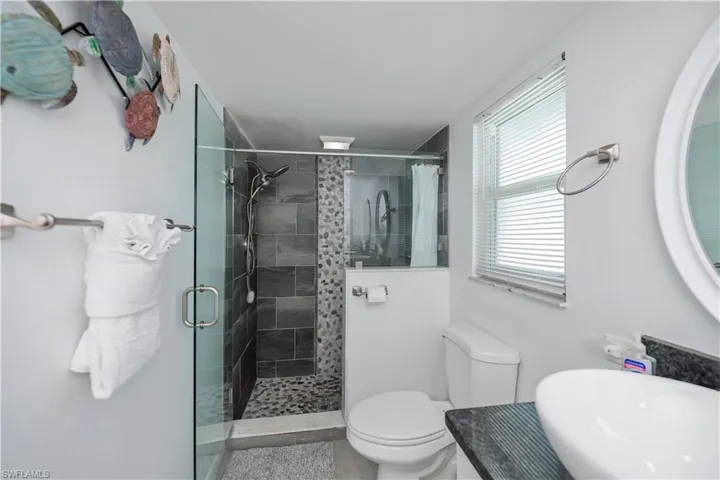Bathroom featuring a stall shower and toilet
