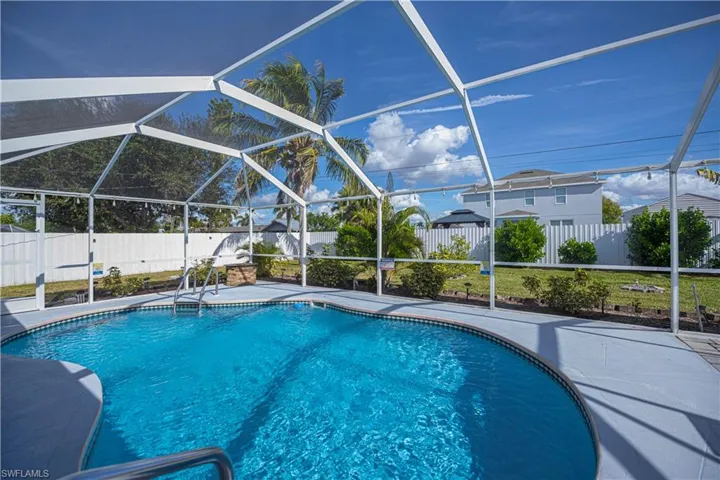 View of swimming pool featuring a fenced backyard, enclosure, a sunroom, and a patio