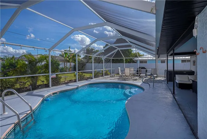 View of pool featuring enclosure, a fenced backyard, and a patio area