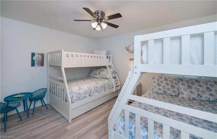Bedroom with wood finished floors and ceiling fan