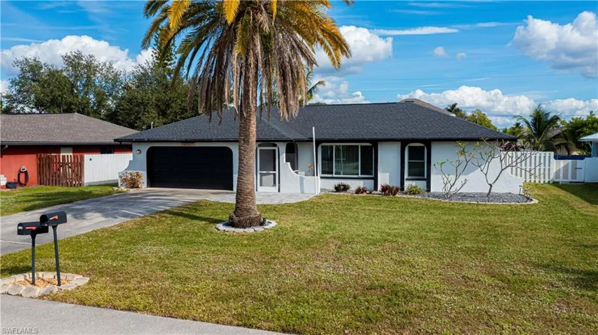 Ranch-style house featuring stucco siding, roof with shingles, driveway, and an attached garage