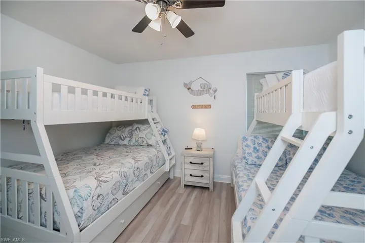 Bedroom with light wood-style flooring and a ceiling fan