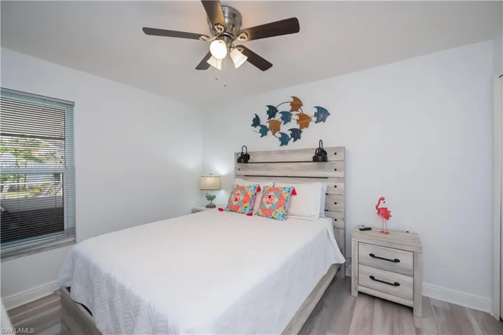 Bedroom with wood finished floors and a ceiling fan